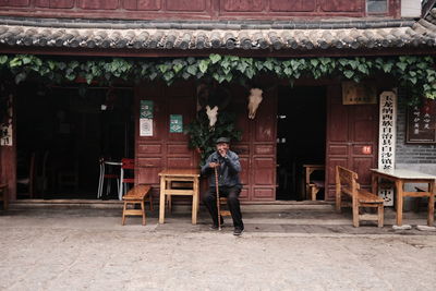 Full length of man on table against building