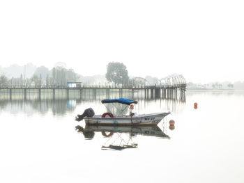 Boat in lake against clear sky