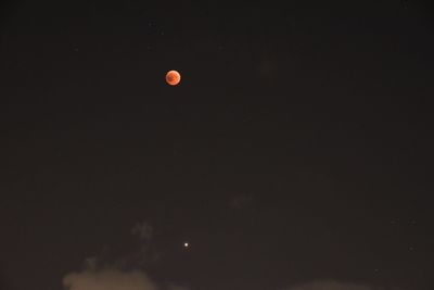 Low angle view of moon against sky at night