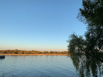 Scenic view of lake against clear blue sky