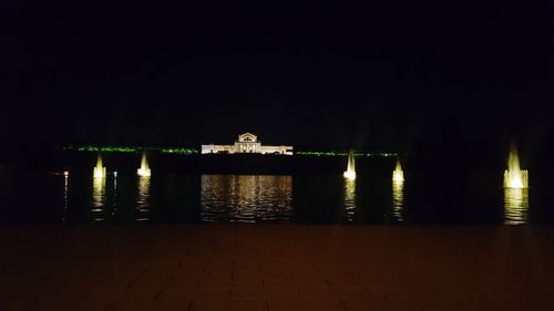 View of illuminated temple against sky at night