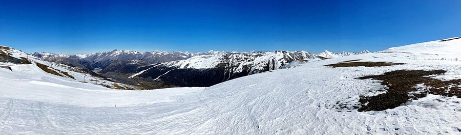 View of snowcapped mountains against blue sky