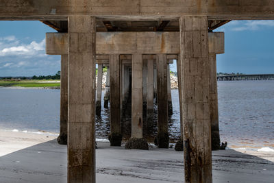 Wooden pier on sea against sky