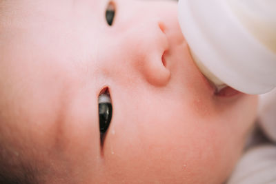 Close-up portrait of baby boy drinking milk