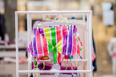 Close-up of multi colored clothes hanging on rack