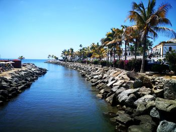 Scenic view of of river estuary and sea against clear blue sky