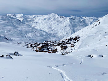 Scenic view of snow covered mountains against sky