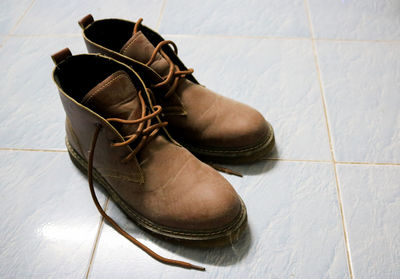 High angle view of shoes on tiled floor