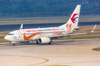 Side view of airplane on airport runway