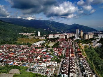 High angle view of houses in town against sky