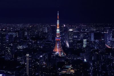 Illuminated tokyo tower and cityscape at night