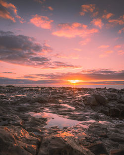 Scenic view of sea against romantic sky at sunset