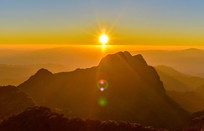 Scenic view of silhouette mountains against sky during sunset