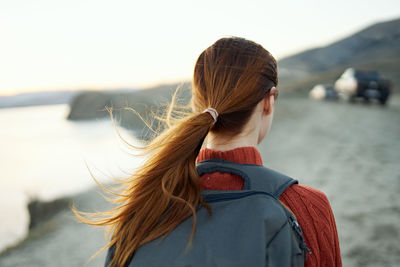 Rear view of woman looking at camera