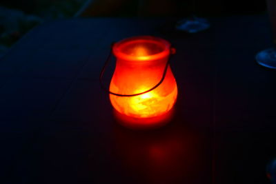 Close-up of lit candle in dark