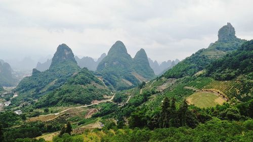 Scenic view of mountains against cloudy sky