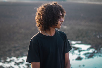 A guy in front of lake