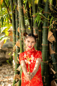 Portrait of a smiling young woman standing outdoors