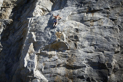 Rear view of man climbing mountain