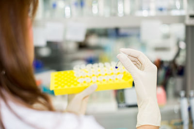 Midsection of scientist working at laboratory