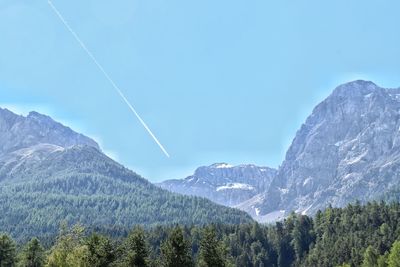 Scenic view of mountains against blue sky