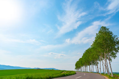 Empty road along countryside landscape