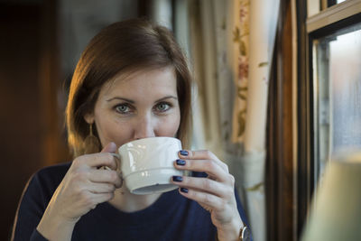 Portrait of beautiful woman having coffee