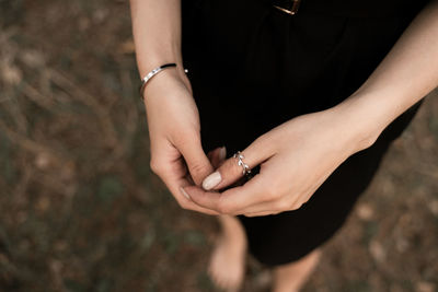 Midsection of woman holding hands