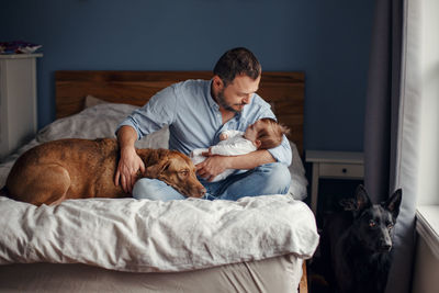 Man and dog on bed at home