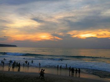 Scenic view of beach against sky during sunset