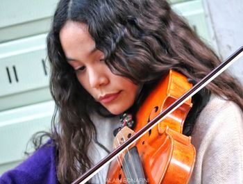 Portrait of a young woman playing guitar