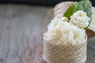 Close-up of white roses in basket