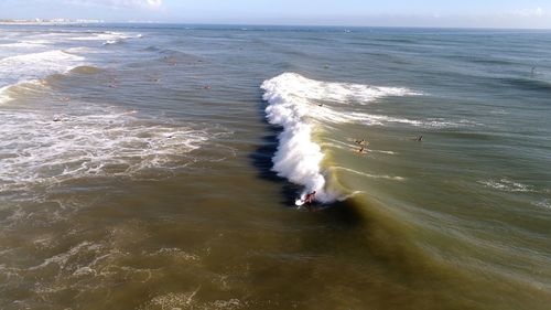High angle view of waves in sea against sky