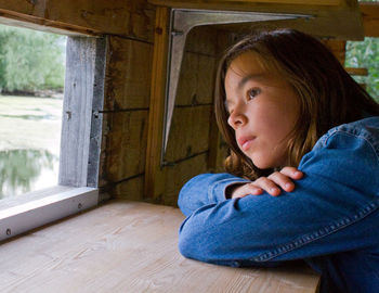 High angle view of young woman looking through window
