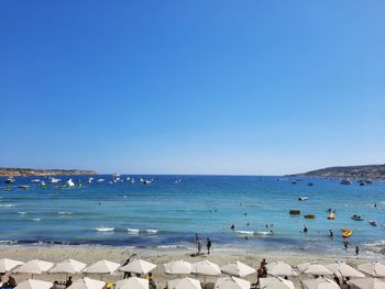 Scenic view of sea against clear blue sky