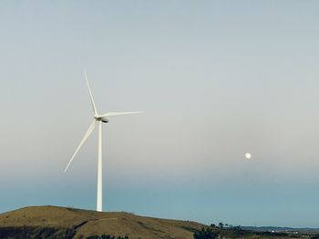 Low angle view of wind turbine against sky