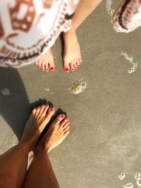 Low section of woman standing on beach
