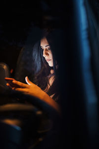 Beautiful woman using smart phone while sitting in car