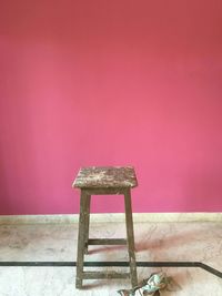 Close-up of wooden table against yellow background