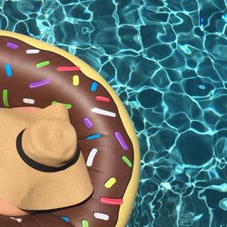 High angle view of woman in inflatable ring on swimming pool