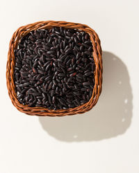 High angle view of chocolate in basket against white background