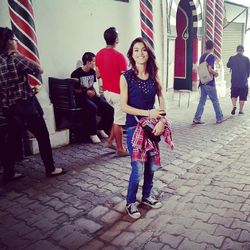 Woman standing on footpath