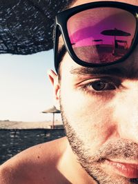 Close-up portrait of young man wearing sunglasses