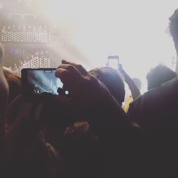 People photographing at music concert