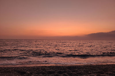 Scenic view of sea against romantic sky at sunset