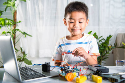 Boy using laptop at home