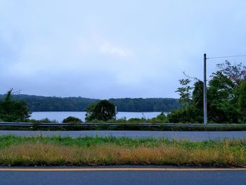 Road by river against sky