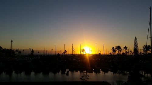 Silhouette of boats in lake during sunset