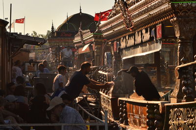 Group of people in temple against buildings in city