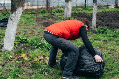 A man removes a large bag of garbage. the concept of caring for the environment. territory cleaning